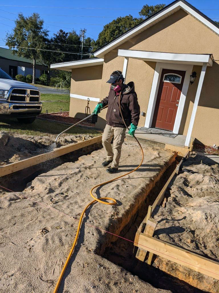 Technician Spraying Pre-construction Termite Treatment
